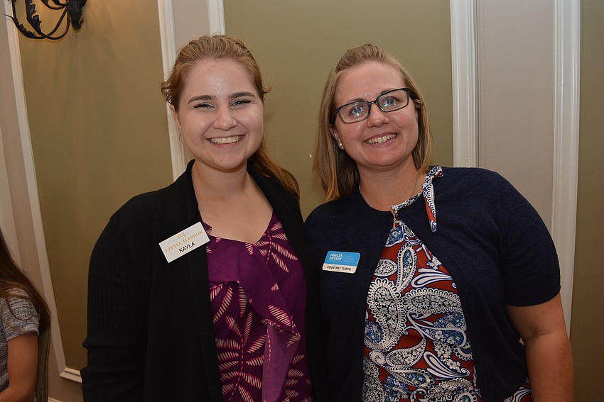 Kayla Montrose, of Little Harbor Resort in Ruskin, talks football with Fawley-Bryant Architeccture's Courtney Turco.