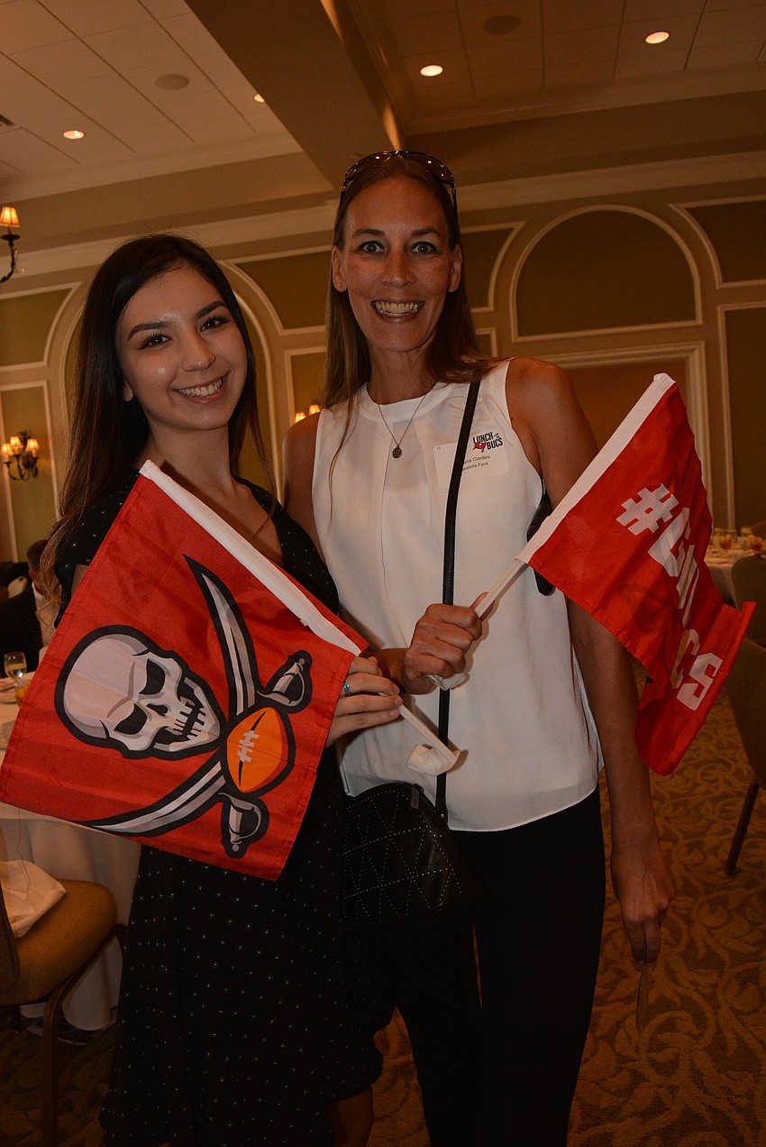 Sarasota Ford's Keishaly Alvarez and Jessica Cordes were excited to have their flags autographed.