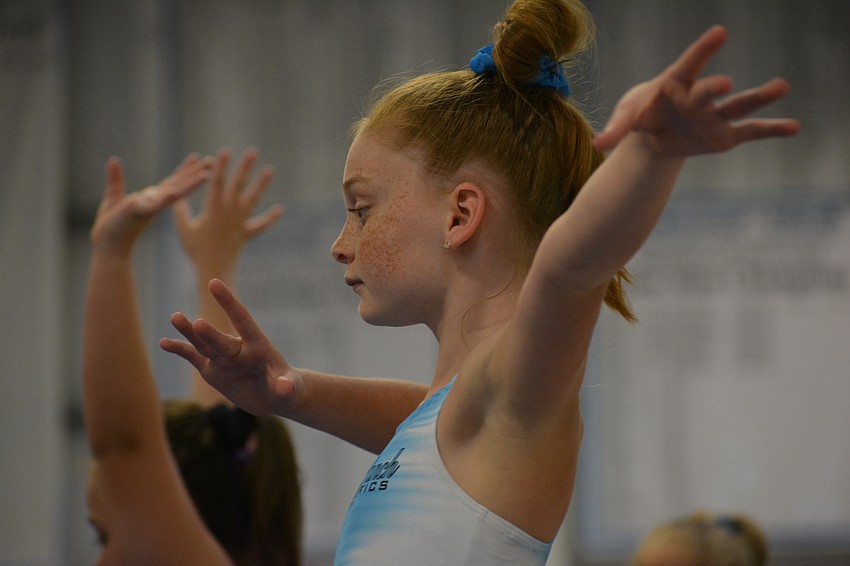 Baylie McKenna balances herself on the beam.