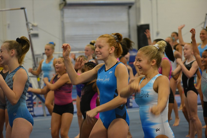 The gymnasts warm up before the start of instruction.