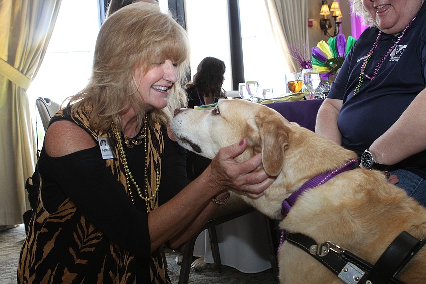 Southeastern Guide Dogs Associate Director of Philanthropy Karen Conkel played with Carson the golden retriever.