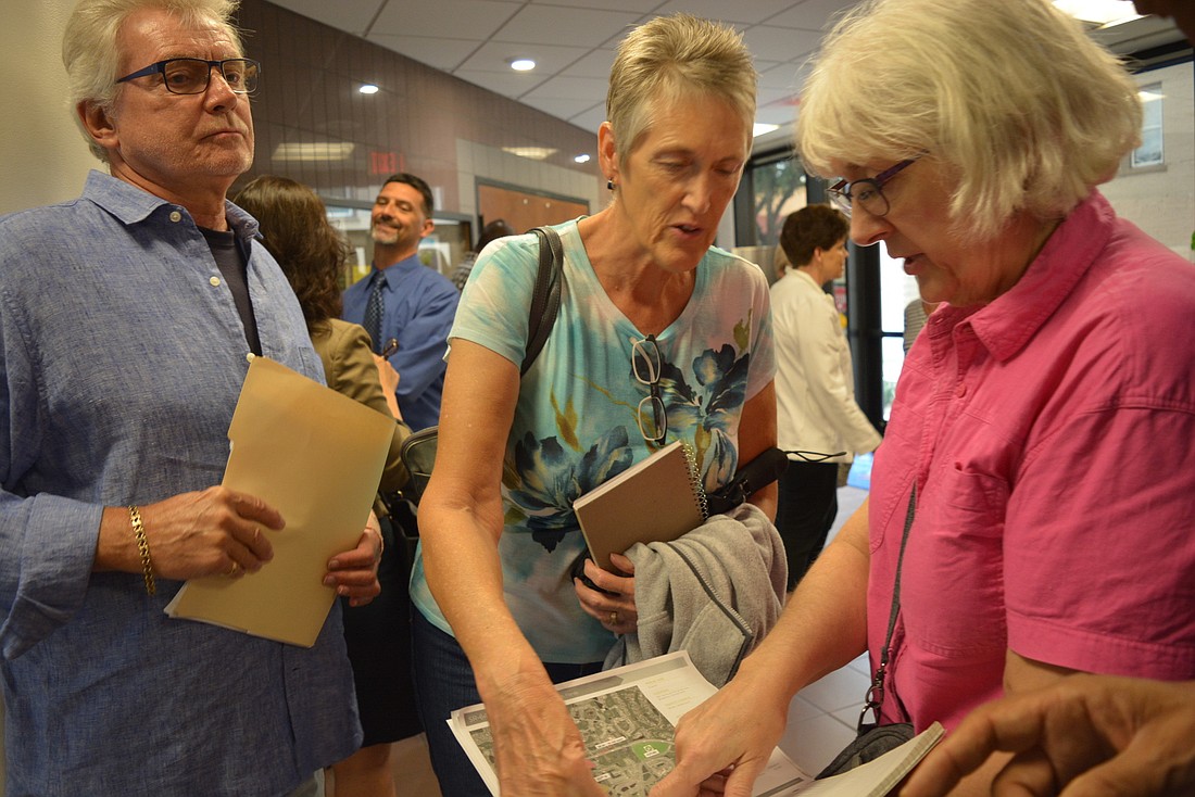 Steve and Becky Jarolin and Jayne Hackett  review maps for proposed changes in Lakewood Ranch near their Eagle Trace homes after the July 11 Planning Commission meeting.  They are worried about having four-story apartments nearby.