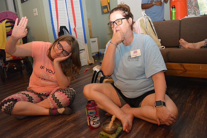 Sarasota's Anabela Burns, 16, raises her hand to show sometimes she becomes angry. Yoga instructor Cheryl Albright then closes off breathing in one side of her nose to show campers breathing techniques to help them relax.