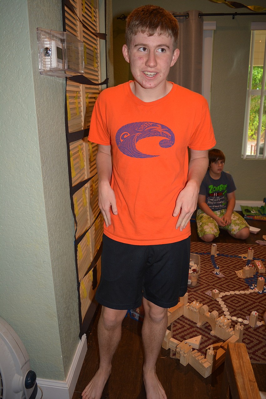 GreyHawk Landing's Luke Penker, 16, hunts for a snack while his friends play games.