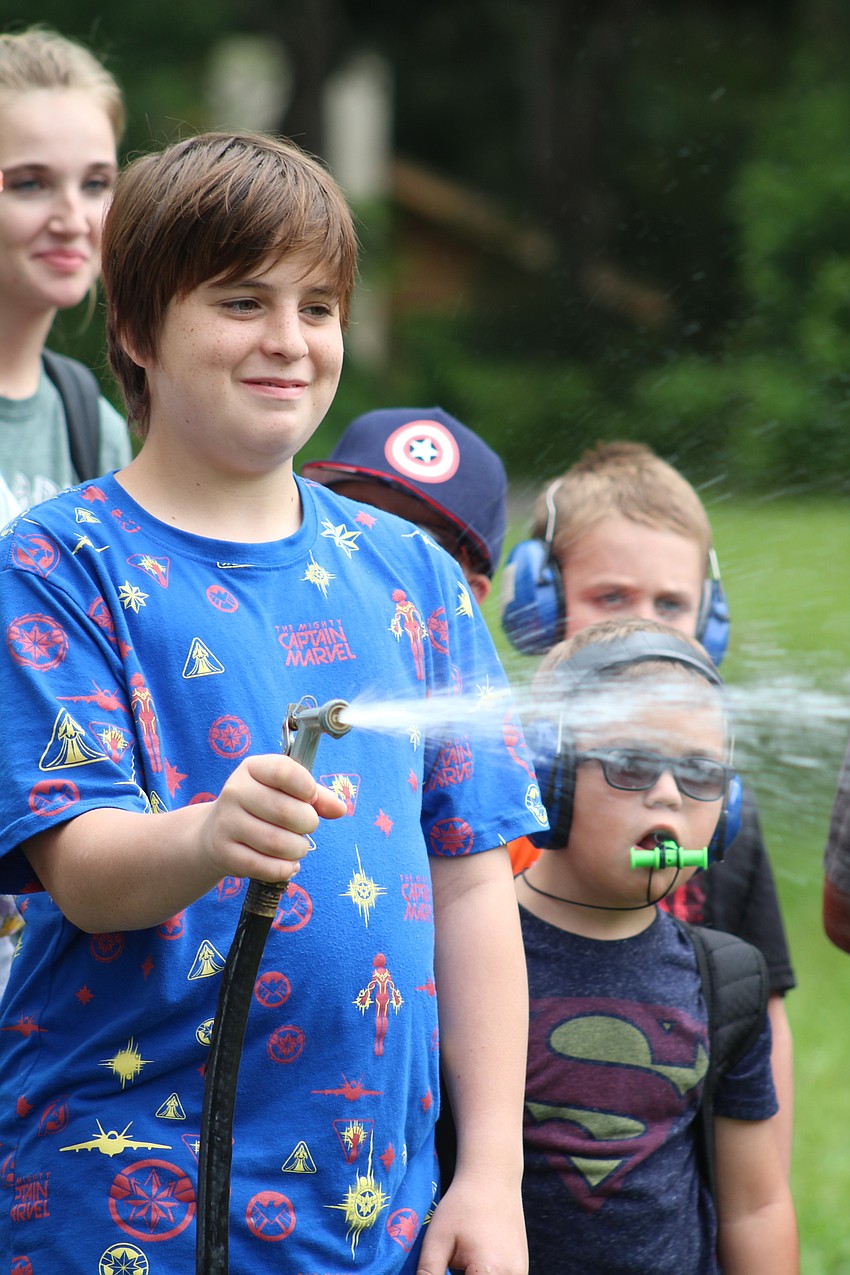 Briggs Rife got to spray a counselor with a hose as part of a morning water activity. Photo courtesy of Devonte Ousley.
