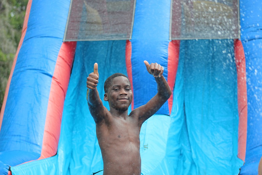 Sarasota's J'qwan Williams loves the inflatable water slide brought on campus for the day. Photo courtesy of Devonte Ousley.