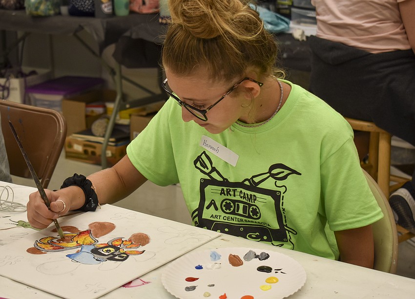 Hannah Adams works on her graffiti fish.