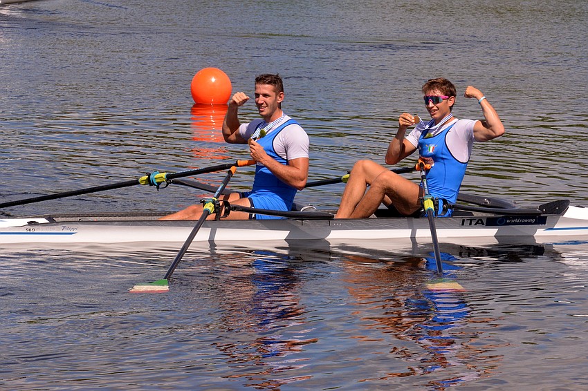 Italy's Luca Chiumento and Andrea Cattaneo muscle up after winning the men's double sculls (6:14.84).