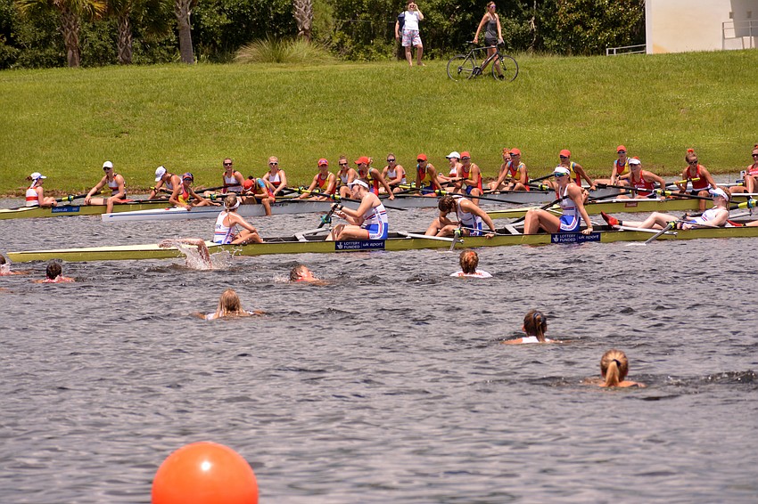 Representatives from the Netherlands swim toward the country's women's eight team after it won the championships' final race (6:17.93).