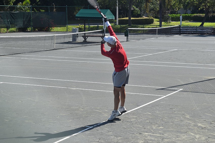Skip Walters works on his serve during practice with tennis pro Kay Thayer.