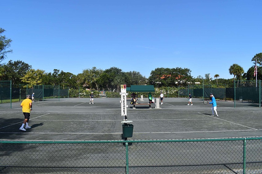 Mel Taub and Marv Hart face off across the net.