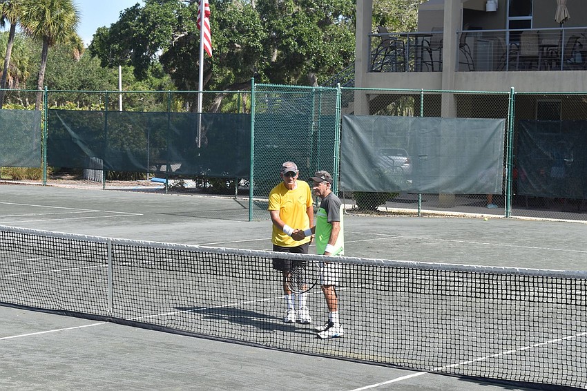 Mel Tab and Enrique Vela shake hands after winning the game.