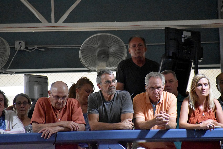 Members leaned over the mezzanine rail and stood on fitness equipment to get a better view.