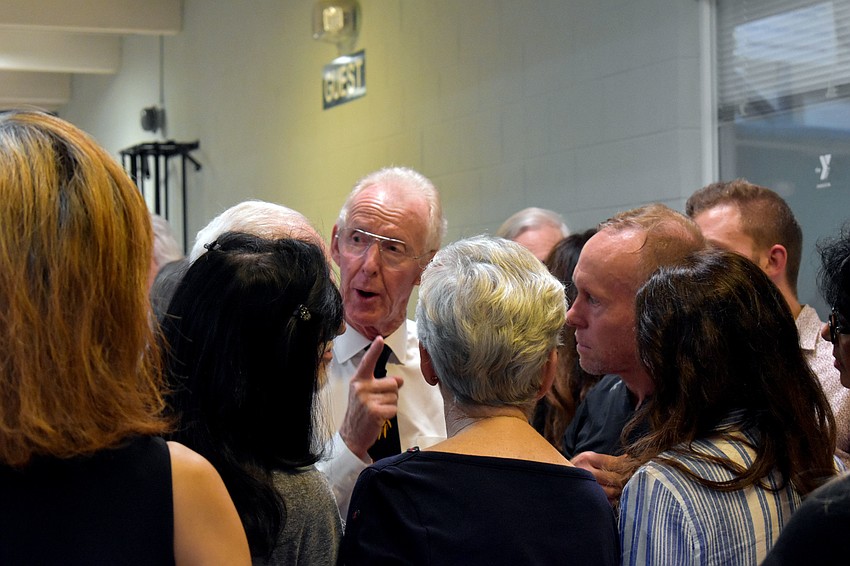 YMCA members swarmed around Interim CEO Steve Bourne to ask questions after the meeting.