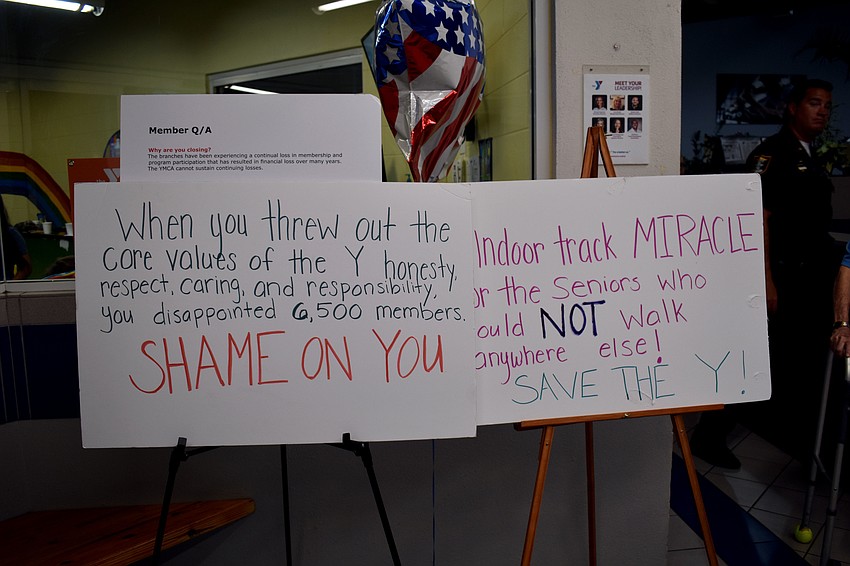 Signs advocating against the closure of the two fitness branches lined the lobby.