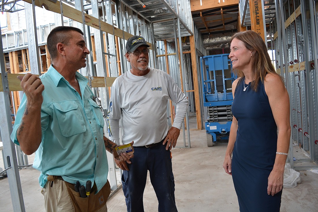 Electricians Tony Gentile and Rick Bradford talk with veterinarian Wendy Ellis about their work inside the future Veterinary  Medical Center at Lakewood Ranch, on State Road 70, slightly west of Post Boulevard.