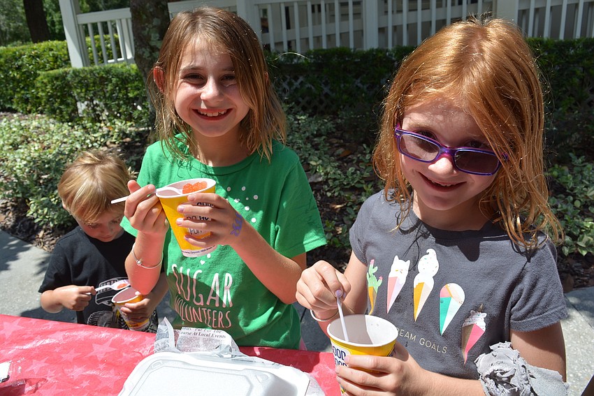 Elliot, Layla and Emeline Korenman, of Greenbrook, get snow cones and hamburgers to celebrate their reading.