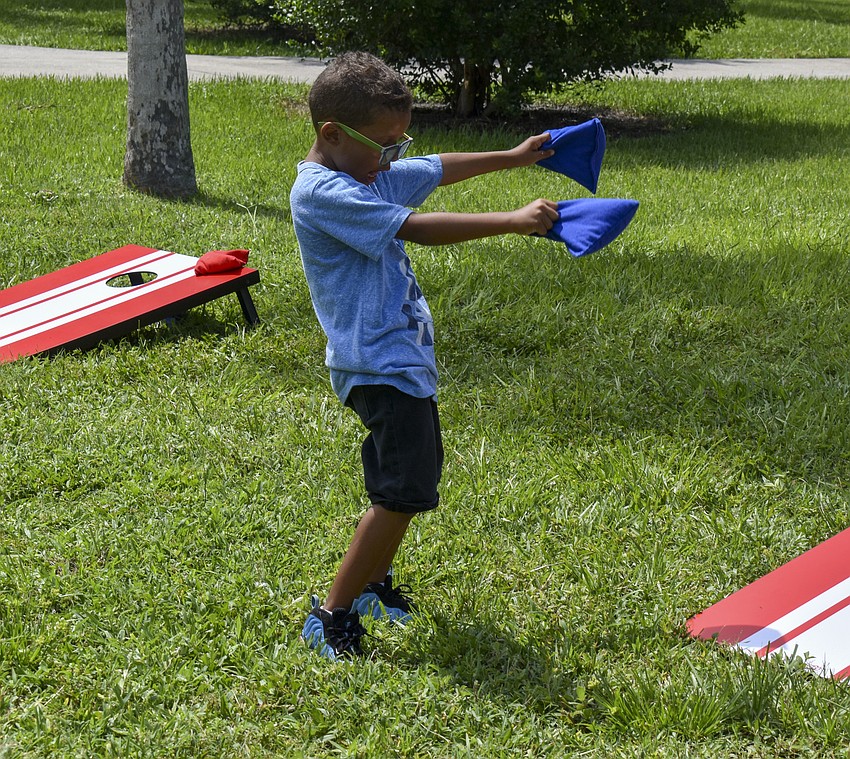 Dearron Hargrove, 6, breaks out his dance moves during a game of cornhole.