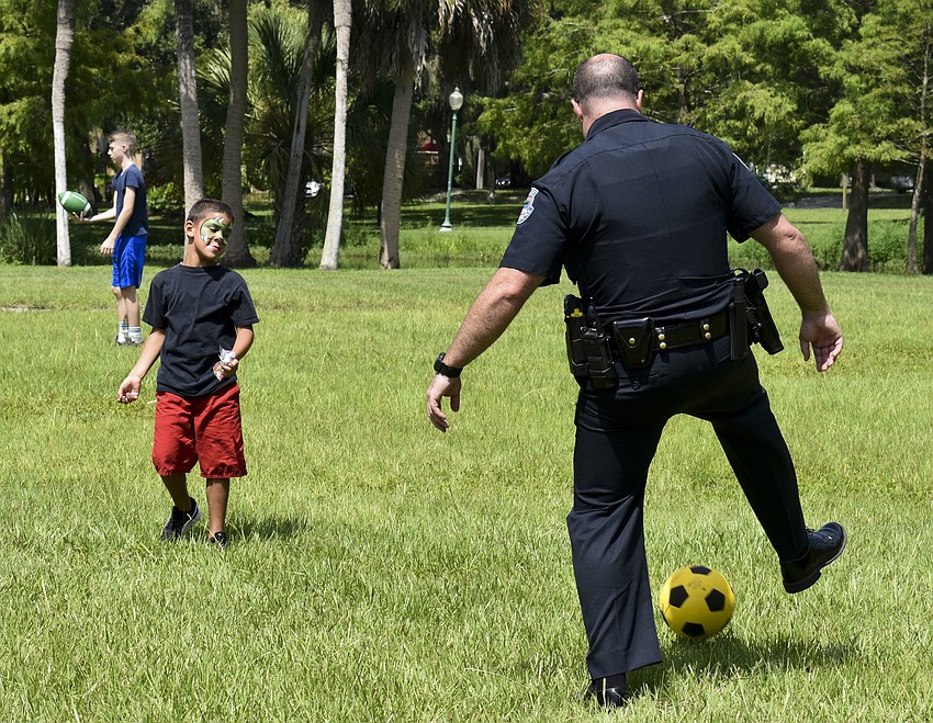 Trye Cook, 6, and Pat Robinson play a game of soccer together.