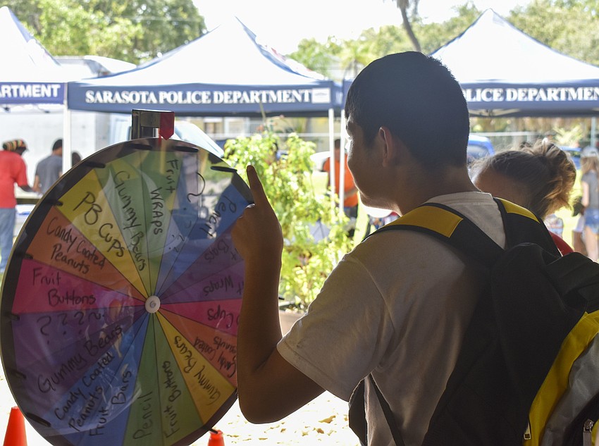 Gabriel Aguilar, 18, spins Trader Joe's wheel of prizes.