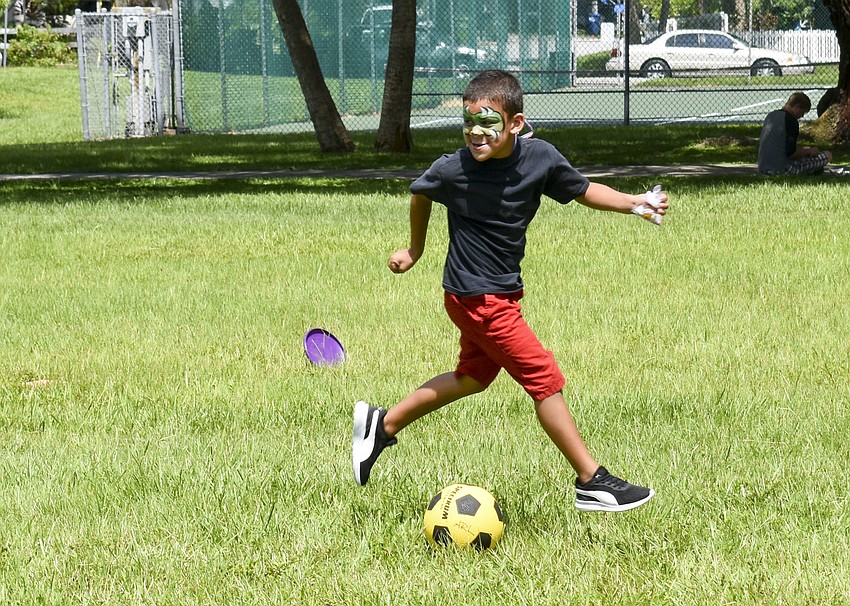 Trye Cook gets ready to kick the soccer ball to one of his teammates.