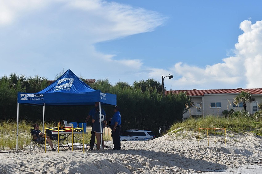 Volunteers man the tent as others bring back the hunt's finds.