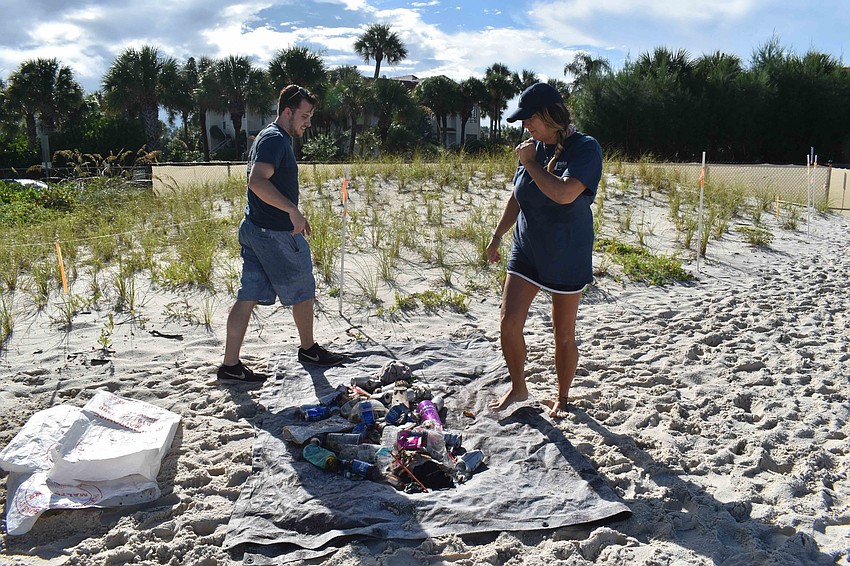 Sean Altice and Tahniya Smith spread out the gathered trash.