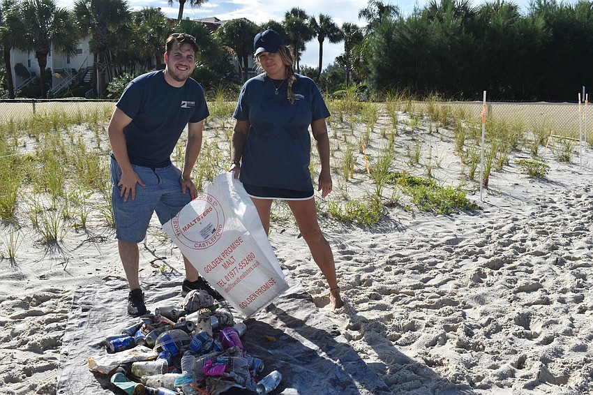 Sean Altice and Tahniya Smith pose with their trash.