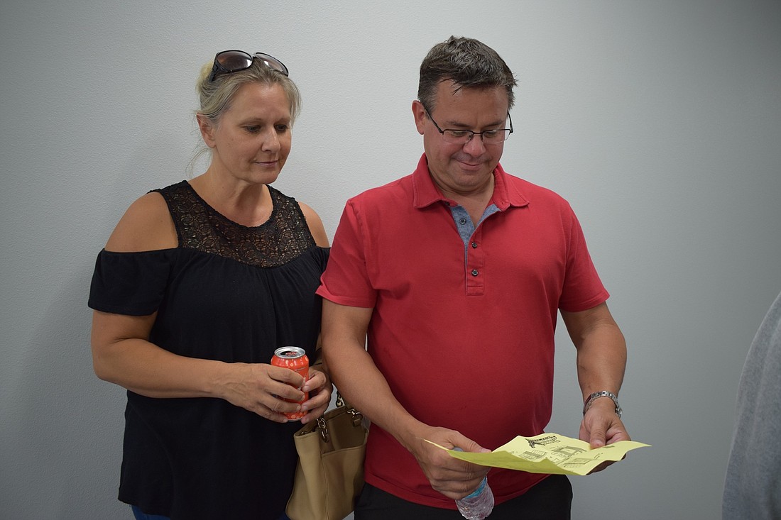 Myakka City residents Lisa Lent and Scott Myre look at a map of Parrish Community High School while they tour the campus Tuesday evening. Their daughter, Madie, 14, will be a freshman at the school this year.