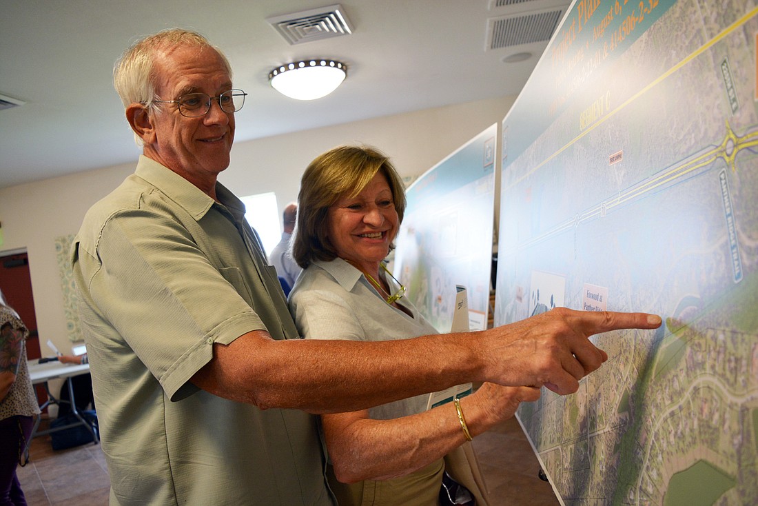 Panther Ridge resident Jim Schneck, with his wife Martine Vande Weghe, finds his home on the map in relation to the construction project.