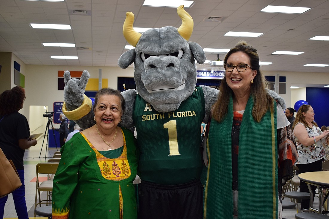 From left, Mona Jain, University of South Florida Sarasota-Manatee mascot Rocky the Bull, and School District of Manatee County Superintendent Cynthia Saunders pose for a photo.