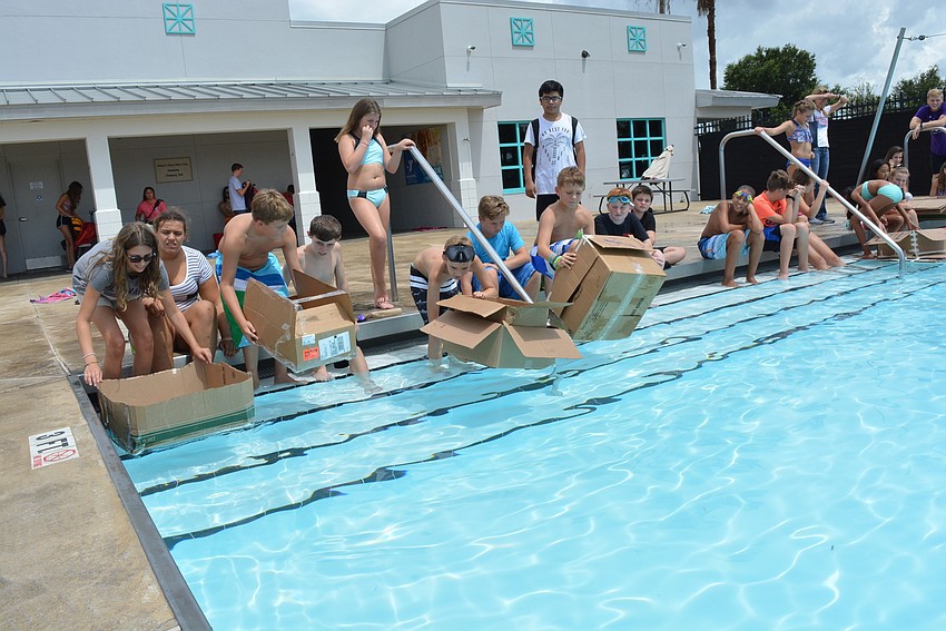Sixth-, seventh- and eighth-grade students get ready to race boats they created.