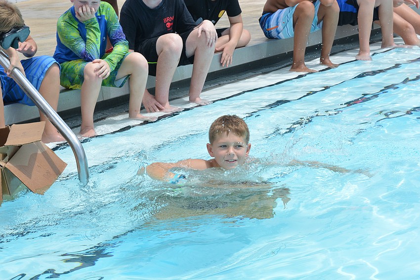 Parrish's Jasper Waybright, 11, put duct tape on the bottom of his boat to help it stay afloat, but it didn't work.