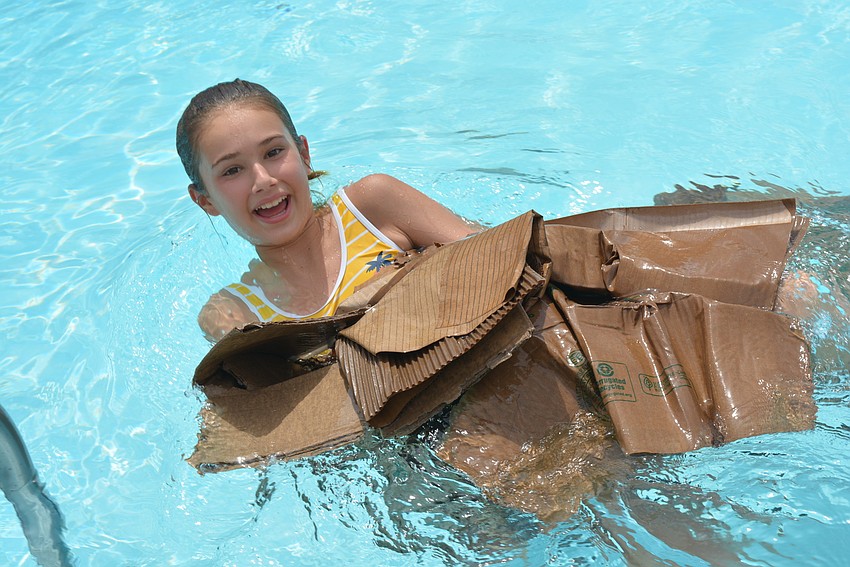 Buffalo Creek Middle School student Natalie Hopkins, 12, won the boat race. She collects the pieces of her boat after the competition.