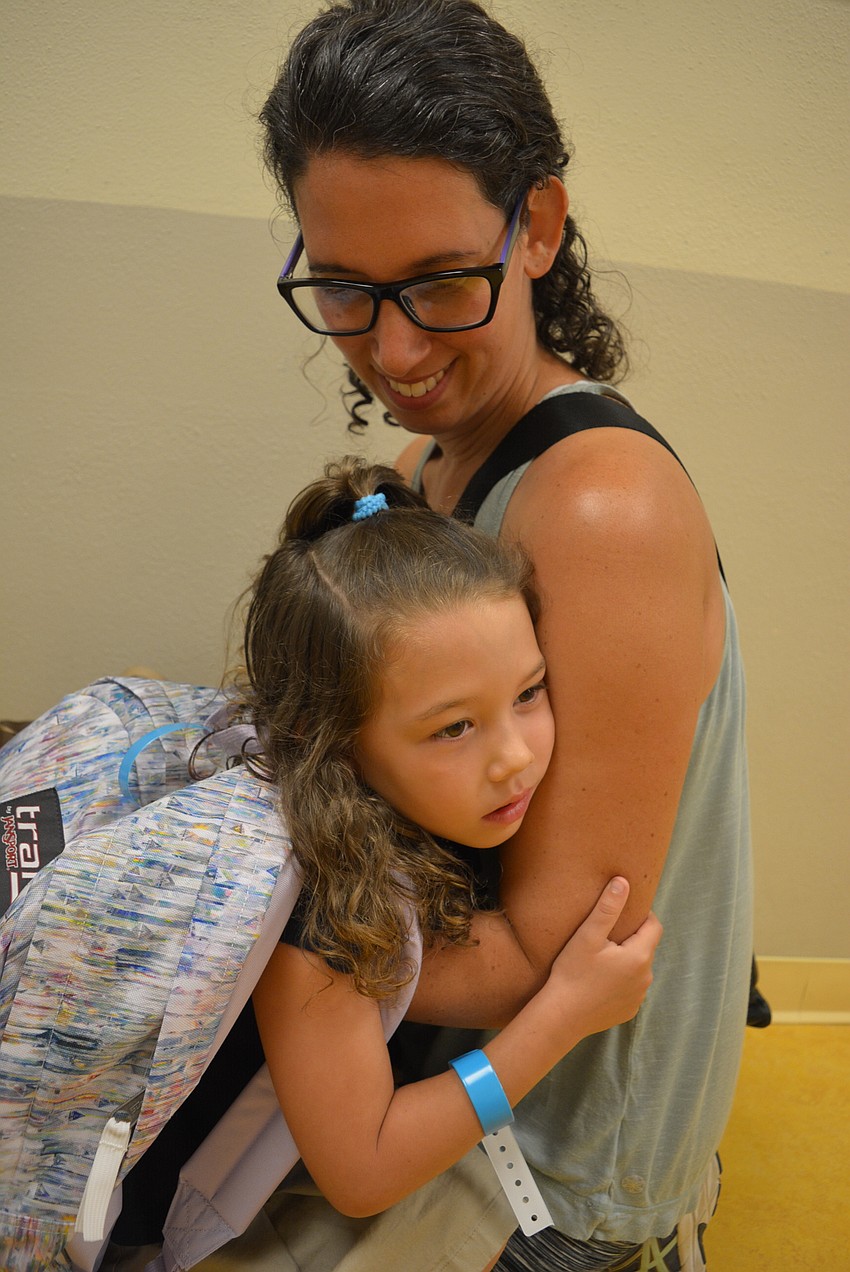 Braden River Elementary School 5-year-old Ava Duff gets a final snuggle with her mom, Ruth Duff, before heading into her first day of kindergarten. They waited in the hallway until teacher Iris Comegno let students into class.