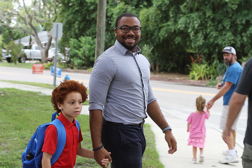 Brian and Vralon Jackson walk hand-in-hand to Southside Elementary. // Harry Sayer