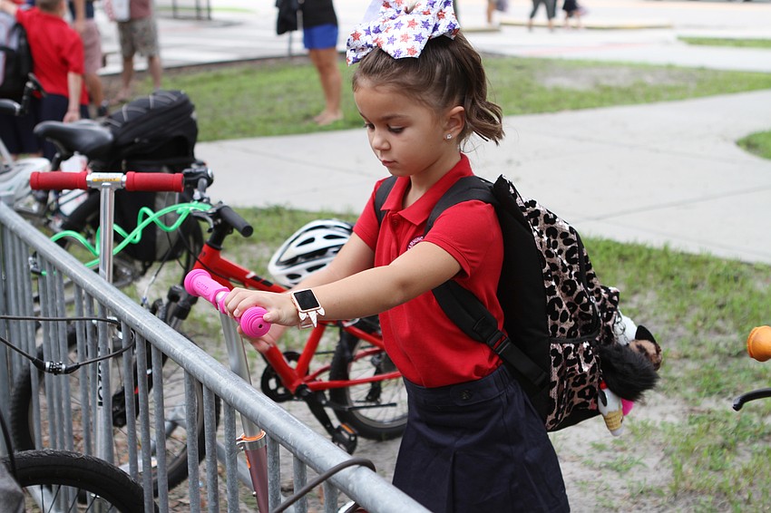 Brielle Kilduff parks her scooter at Southside Elementary. // Harry Sayer