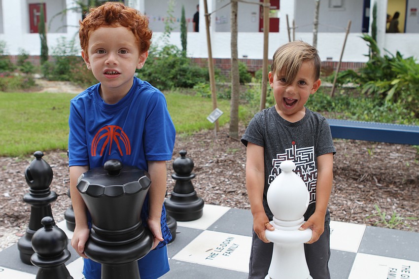 Dylan Sobol and Sebastian Harvey work on their chess moves outside of Southside Elementary. // Harry Sayer