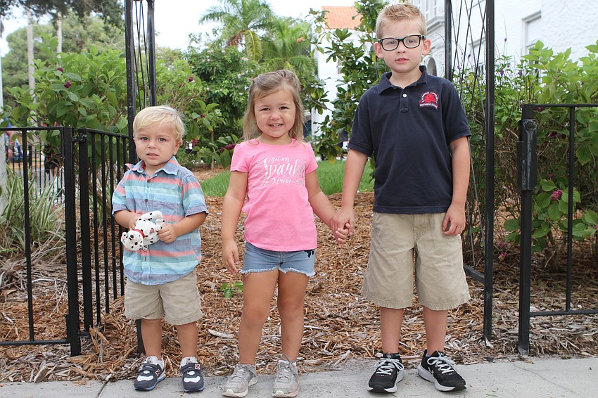 Jackson, Porter and Stella McCoi relax a moment outside of Southside Elementary. // Harry Sayer