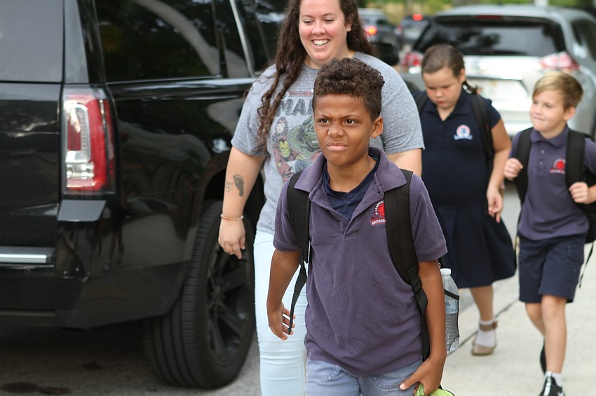 Mosaik Williams prepares himself for his first day of fourth grade as he walks to Southside Elementary. // Harry Sayer