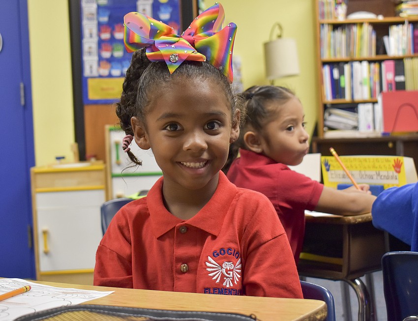 Eyva Theodore shows off her rainbow bow on her first day of kindergarten at Gocio Elementary School. // Whitney Elfstrom