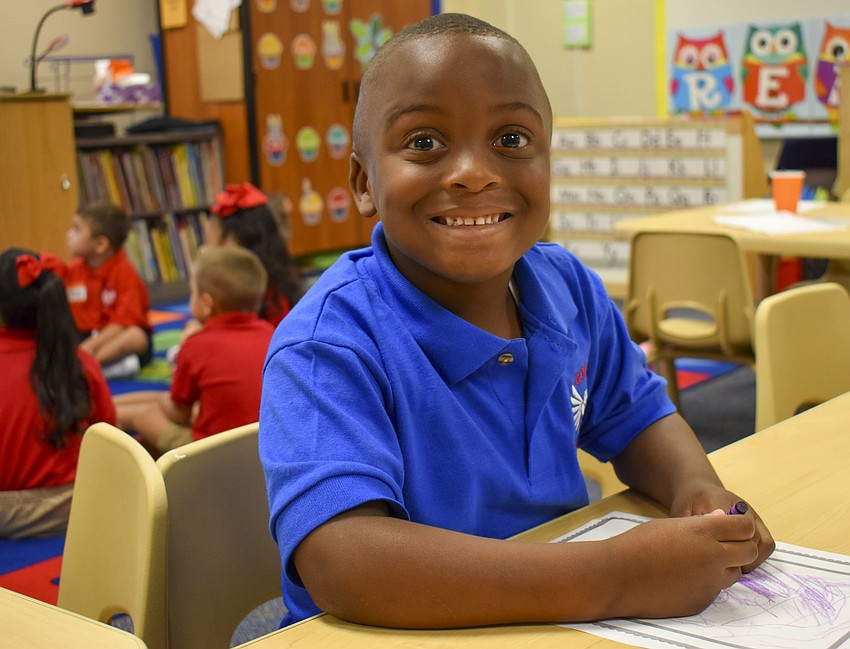 Kayden Clyburn colors before his first pre-K class starts at Gocio Elementary School. // Whitney Elfstrom