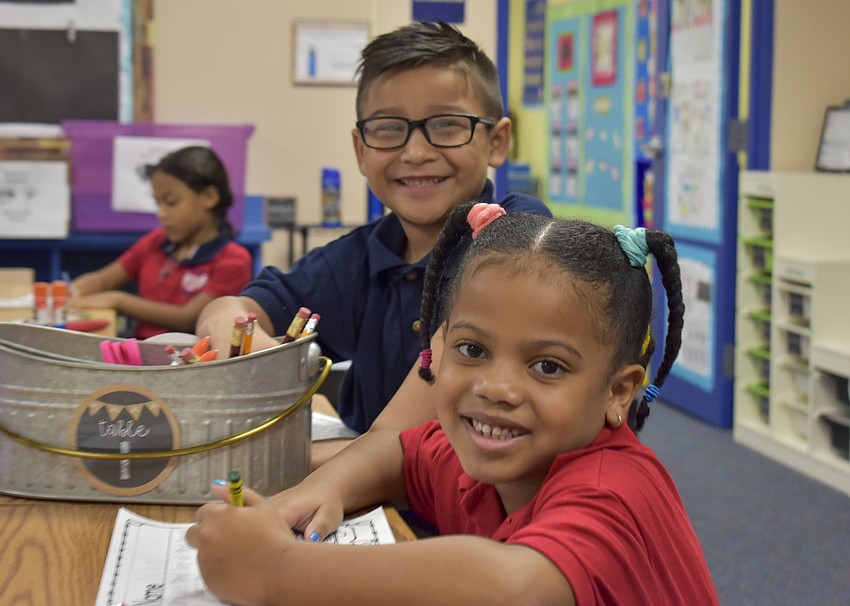 Nina Mortimer and Irvin Puga-Tapia smile on their first day of first grade at Gocio Elementary School. // Whitney Elfstrom