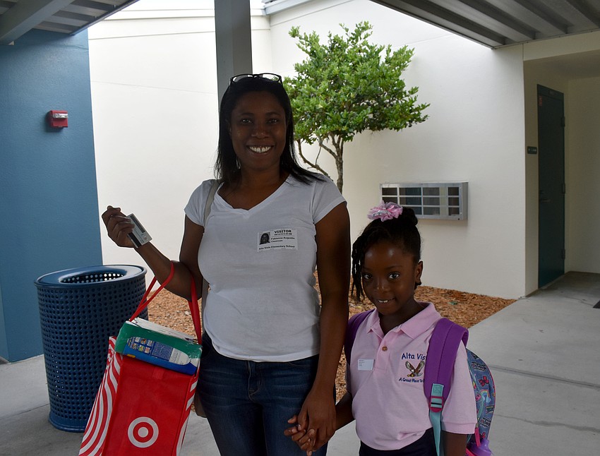 Fabienne Augustin and first grader Abigail Denize are loaded up with school supplies for the year at Alta Vista Elementary. // Brynn Mechem