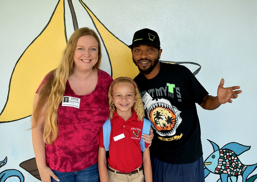 Susan Crittenden, second-grade student Summer Harris and Dax Harris take a photo opp in front of Alta Vista Elementary’s mural wall. // Brynn Mechem