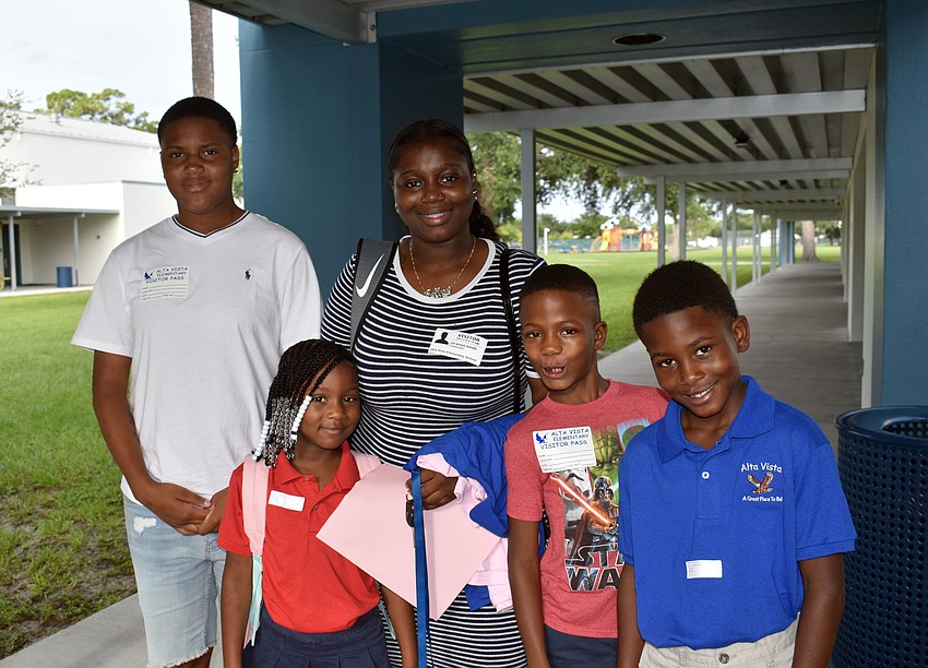 t’s a party of five as Sha’Miya Williams, 1st grade student Lyric Chisholm, Ja’Anna Smith, Curtis Thomas and 4th grade student Quintonio Chisholm walk the halls of Alta Vista Elementary. // Brynn Mechem