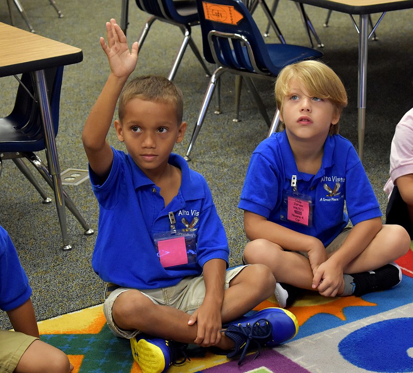 Hezekiah Quamina and Cody Zarves wait for their turn to be called on during the first day of kindergarten at Alta Vista Elementary. // Brynn Mechem