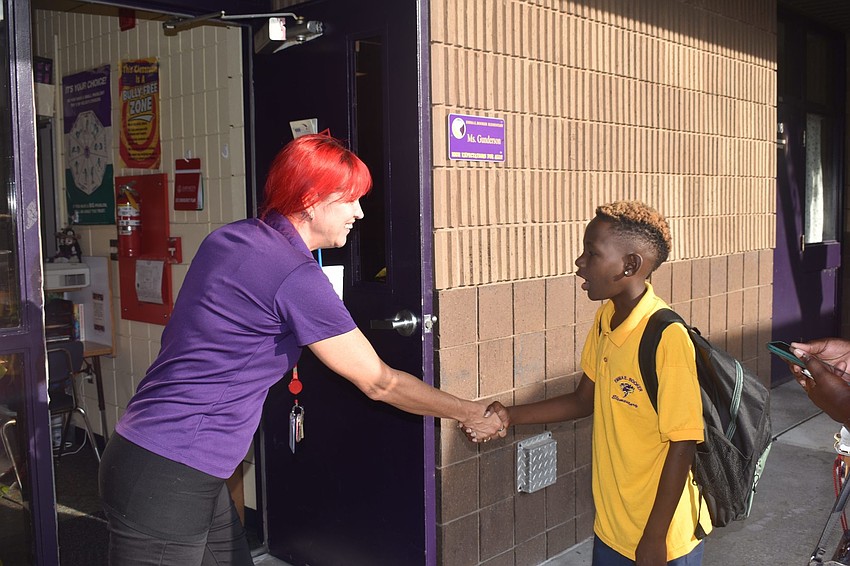 Sherry Gunderson shakes hands with Ar'Marian Gilchrist, who was excited to be in her fifth-grade class at Emma E. Booker Elementary this year. // Nathalie Kaemmerer