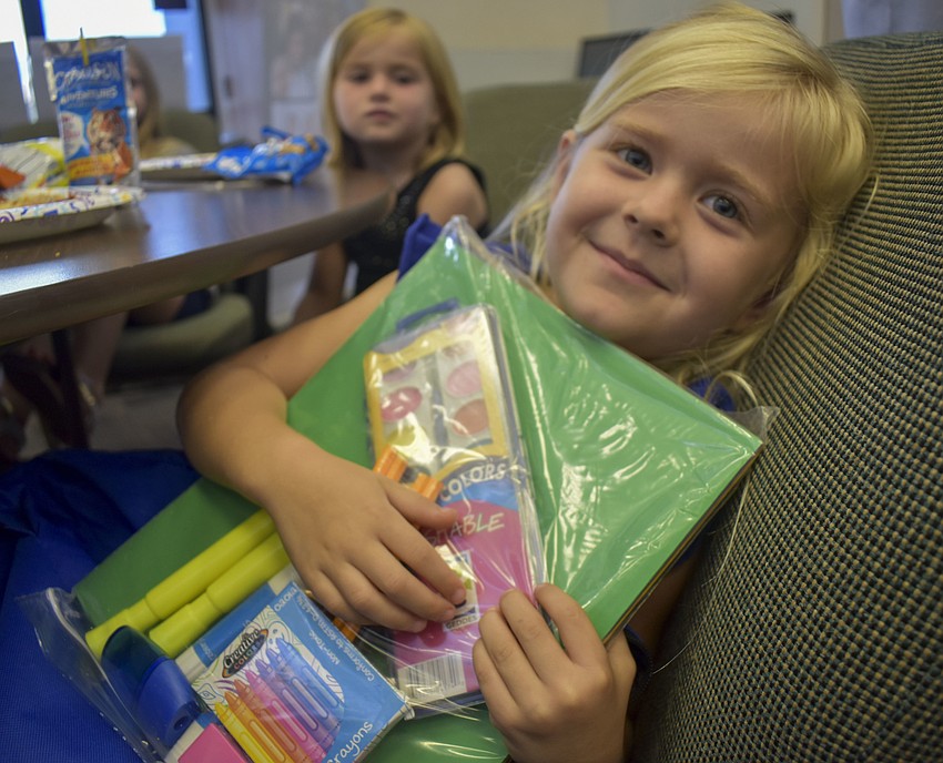 Abbey Brett, 5, loves her new school supplies.