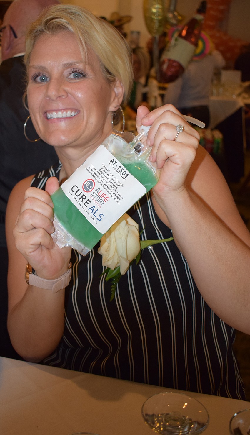 Shaina Swan shows off her speciality cocktail, AT-1501, served in IV bags.  The real AT-1501 is an antibody produced by the ALS Therapy Development Institute and it protects nerves against the progression of ALS.